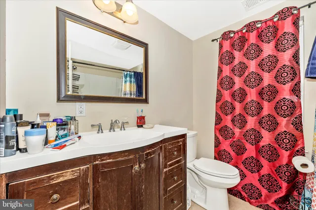 a bathroom with a sink a toilet and mirror
