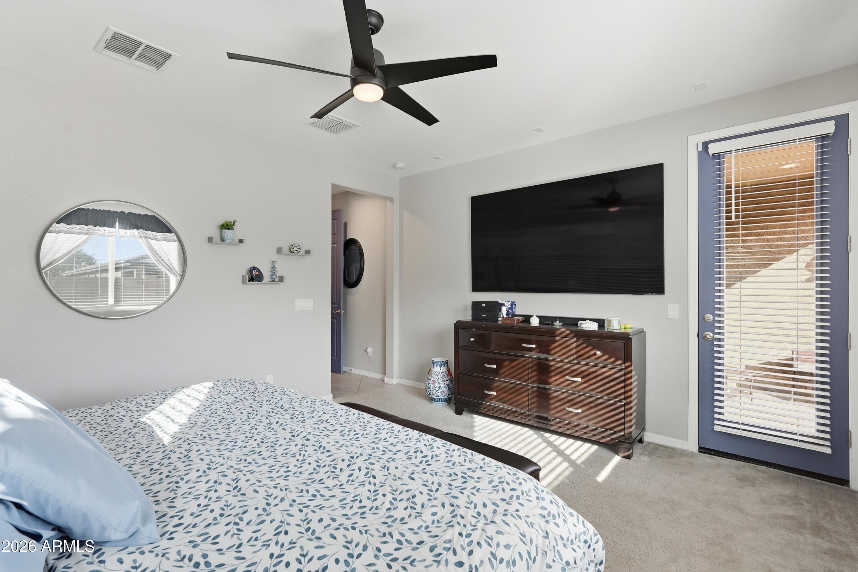 15727 West Madison Street Goodyear, AZ 85338 - Photo 23 of 41 a living room with furniture and a flat screen tv