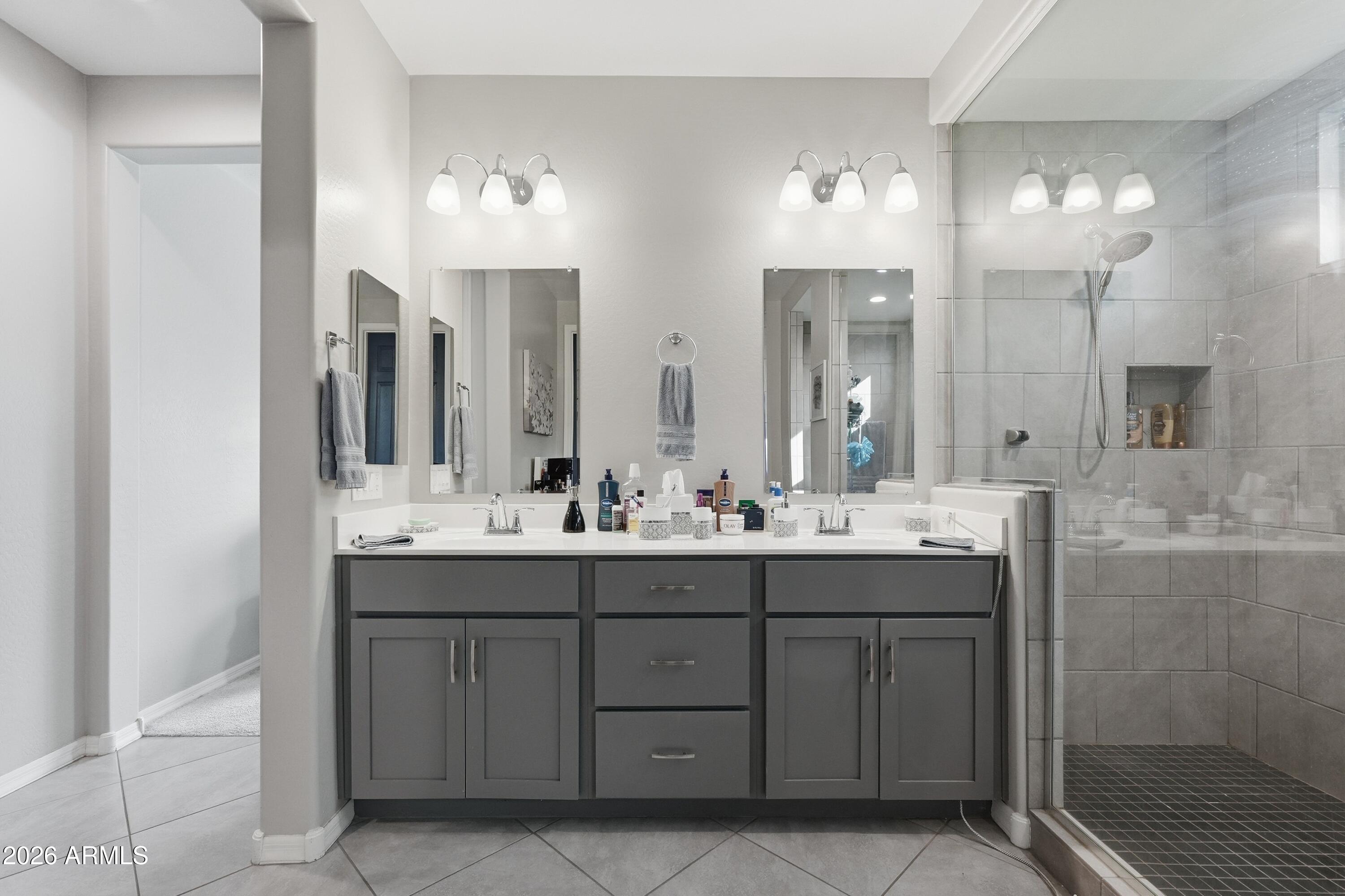 15727 West Madison Street Goodyear, AZ 85338 - Photo 28 of 41 a bathroom with double sink and a mirror