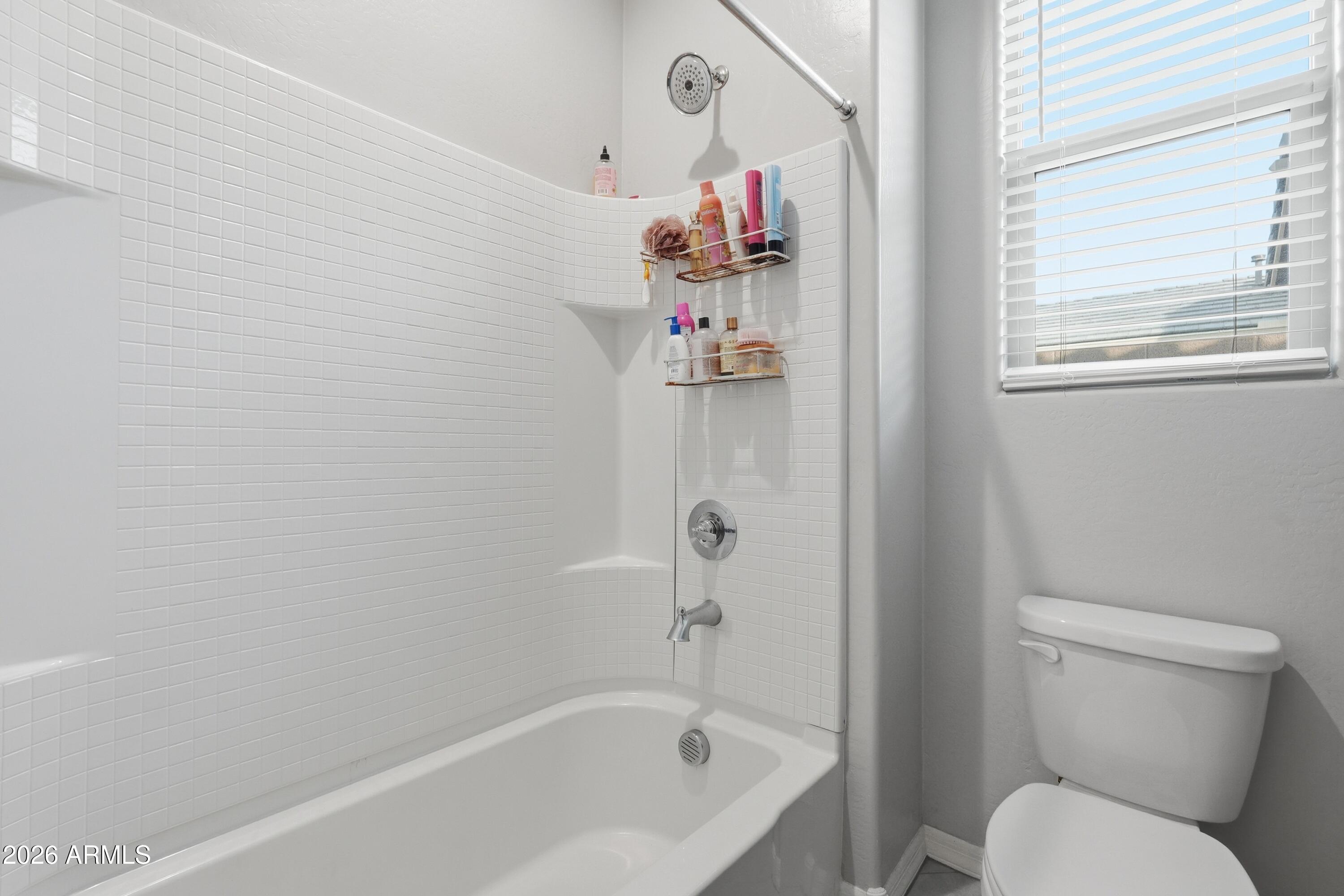 15727 West Madison Street Goodyear, AZ 85338 - Photo 33 of 41 a bath room with a toilet and a shower