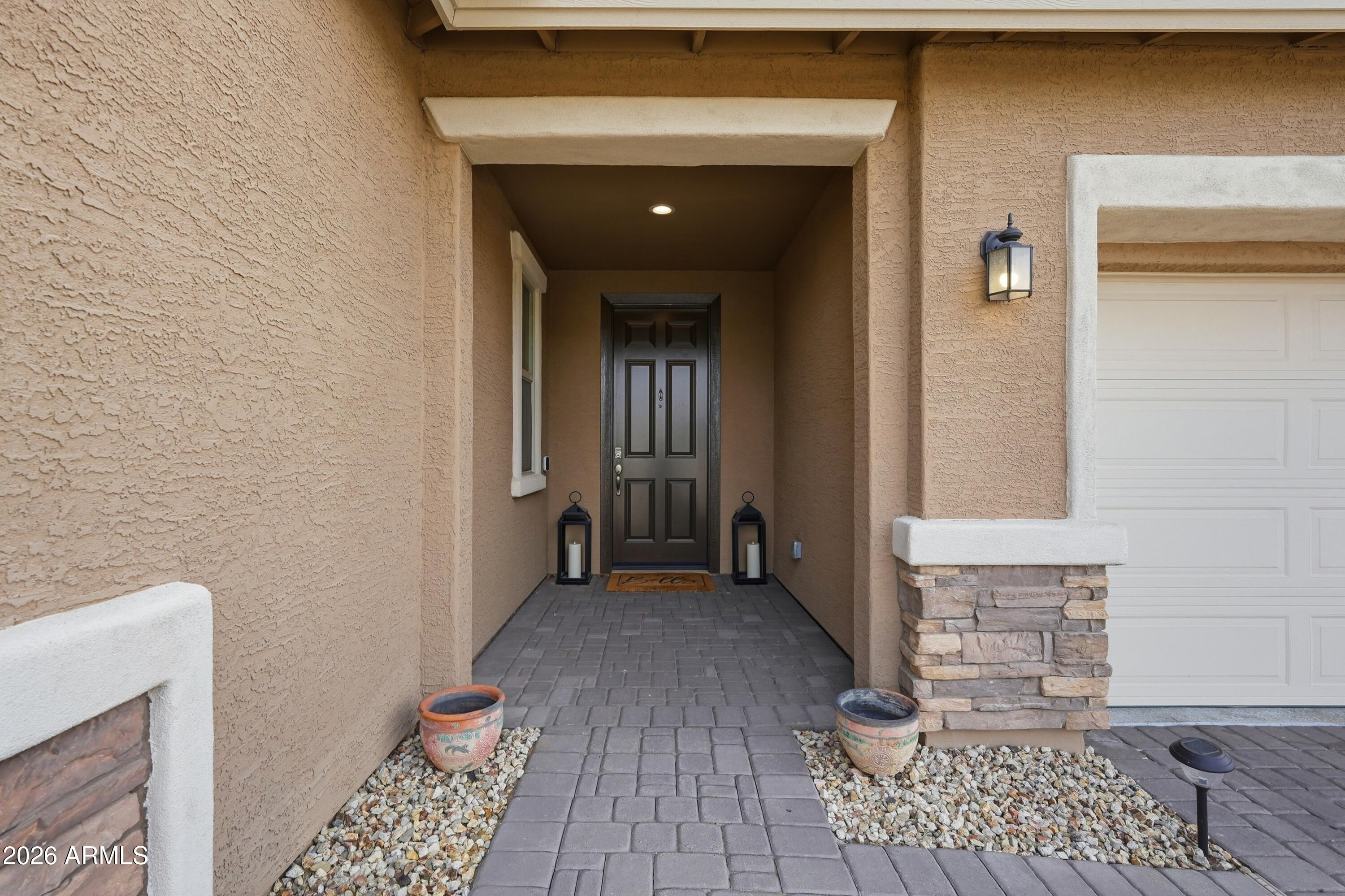15727 West Madison Street Goodyear, AZ 85338 - Photo 4 of 41 a view of a hallway with wooden floor and a living room