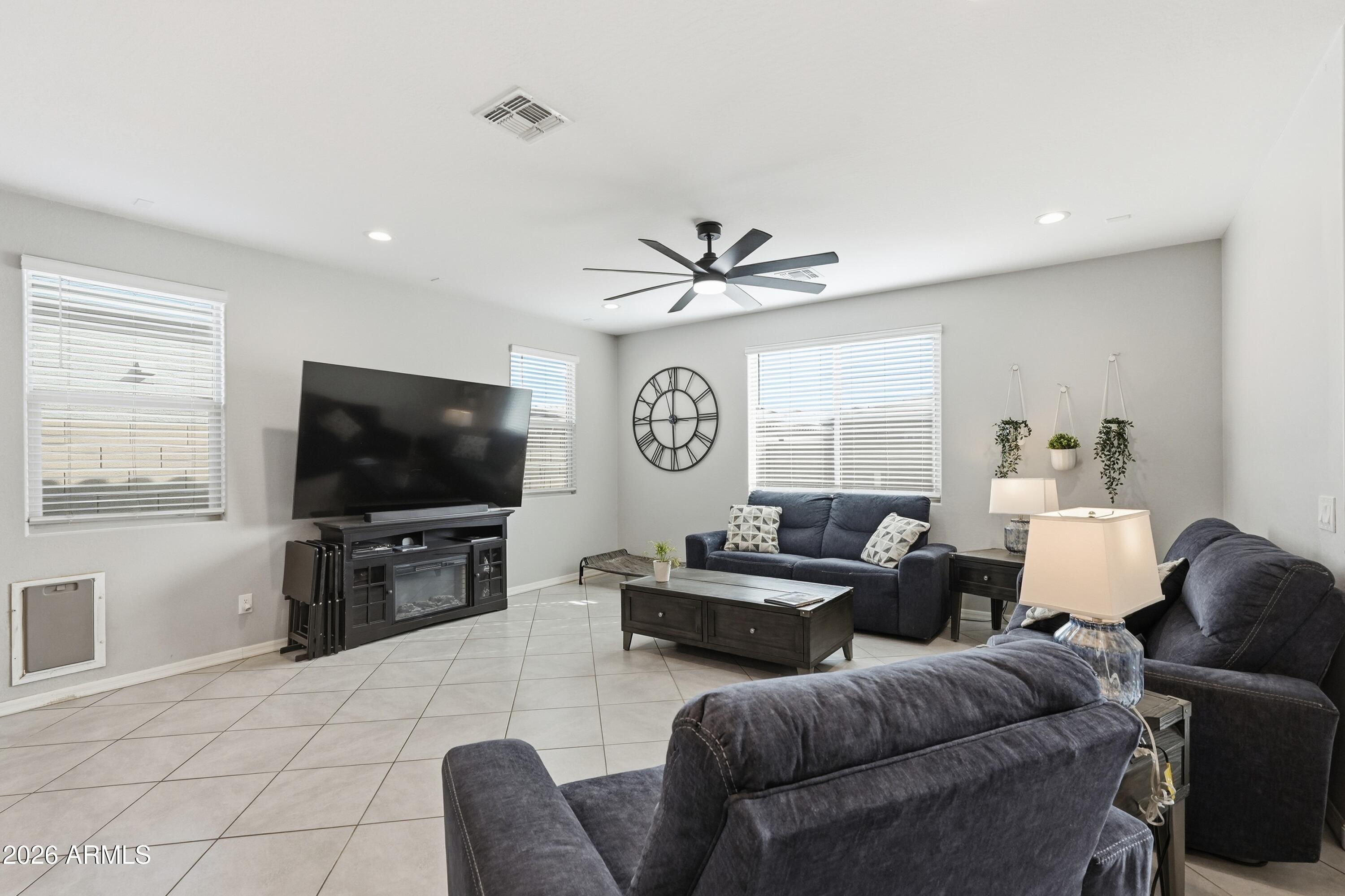 15727 West Madison Street Goodyear, AZ 85338 - Photo 8 of 41 a living room with furniture and a flat screen tv
