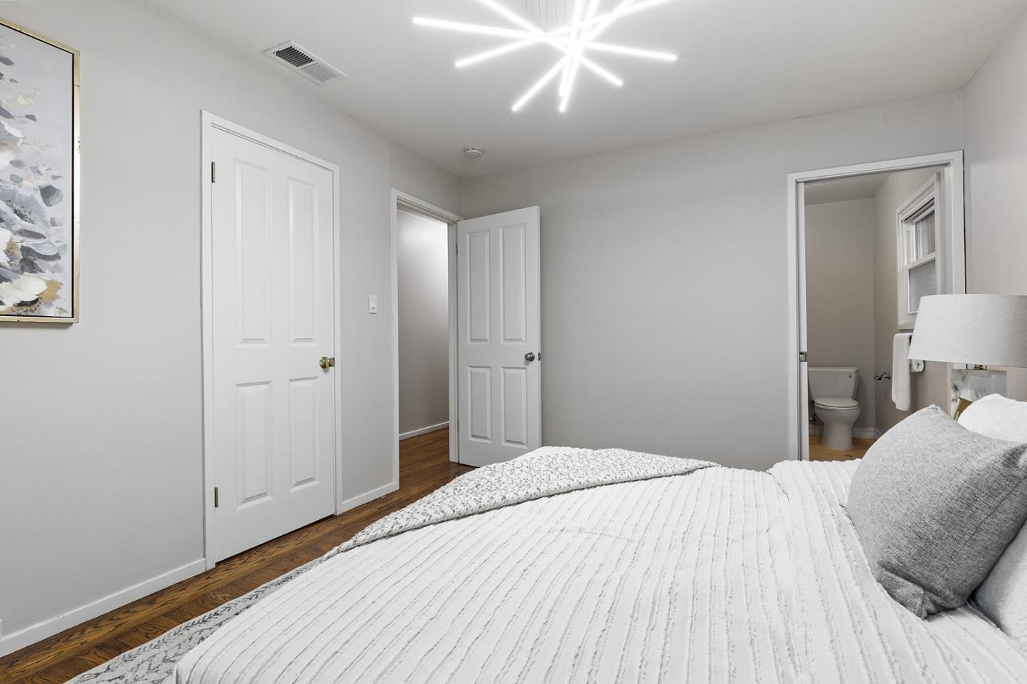 117 Hedge Road Menlo Park, CA 94025 - Photo 12 of 23 a bedroom with a large bed and a chandelier