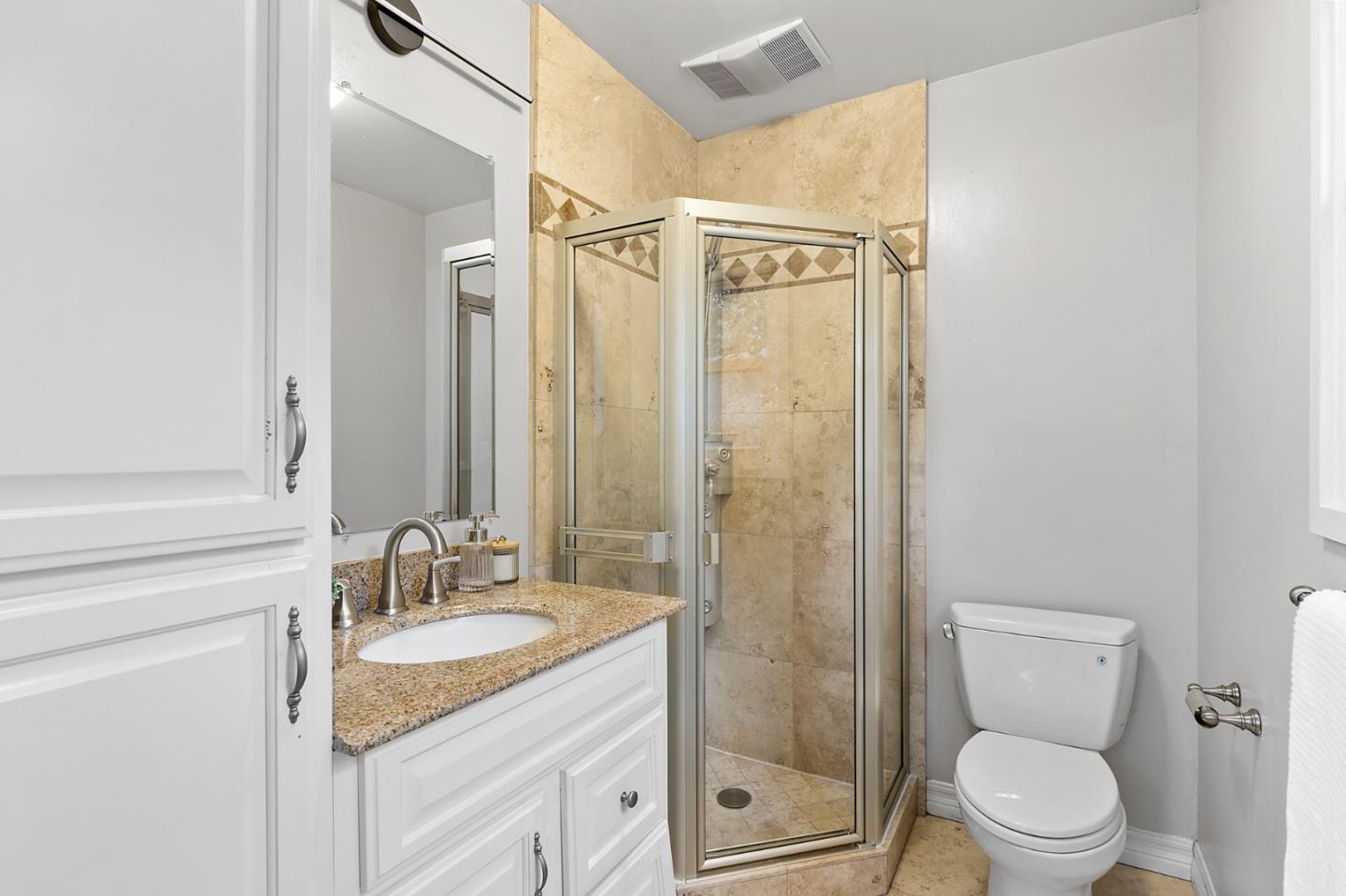 117 Hedge Road Menlo Park, CA 94025 - Photo 18 of 23 a bathroom with a granite countertop sink a toilet and shower