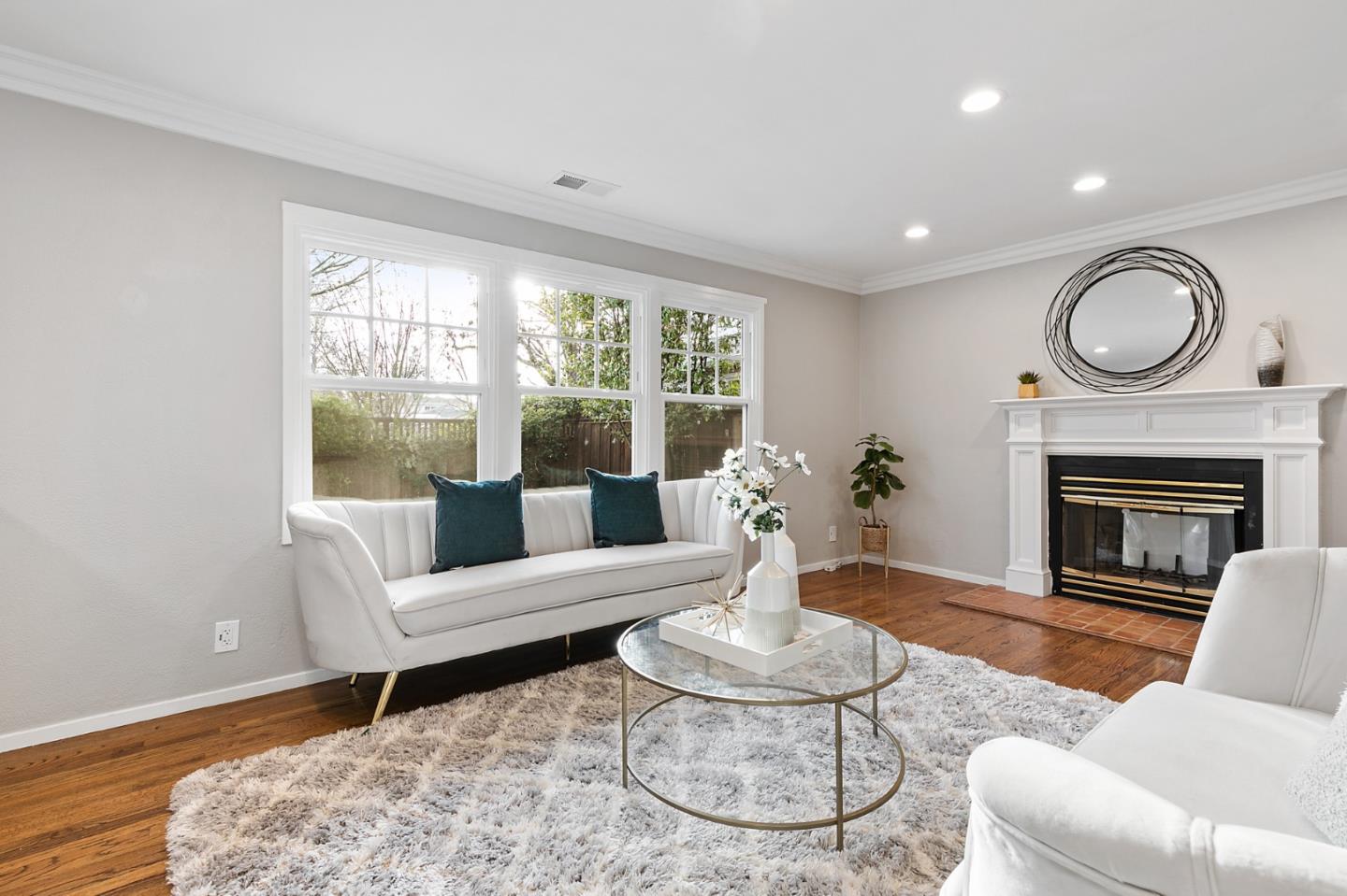 117 Hedge Road Menlo Park, CA 94025 - Photo 5 of 23 a living room with furniture a fireplace and a large window