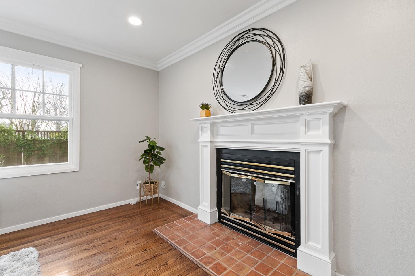 117 Hedge Road Menlo Park, CA 94025 - Photo 6 of 23 a view of a livingroom with a fireplace a potted plant and a fireplace