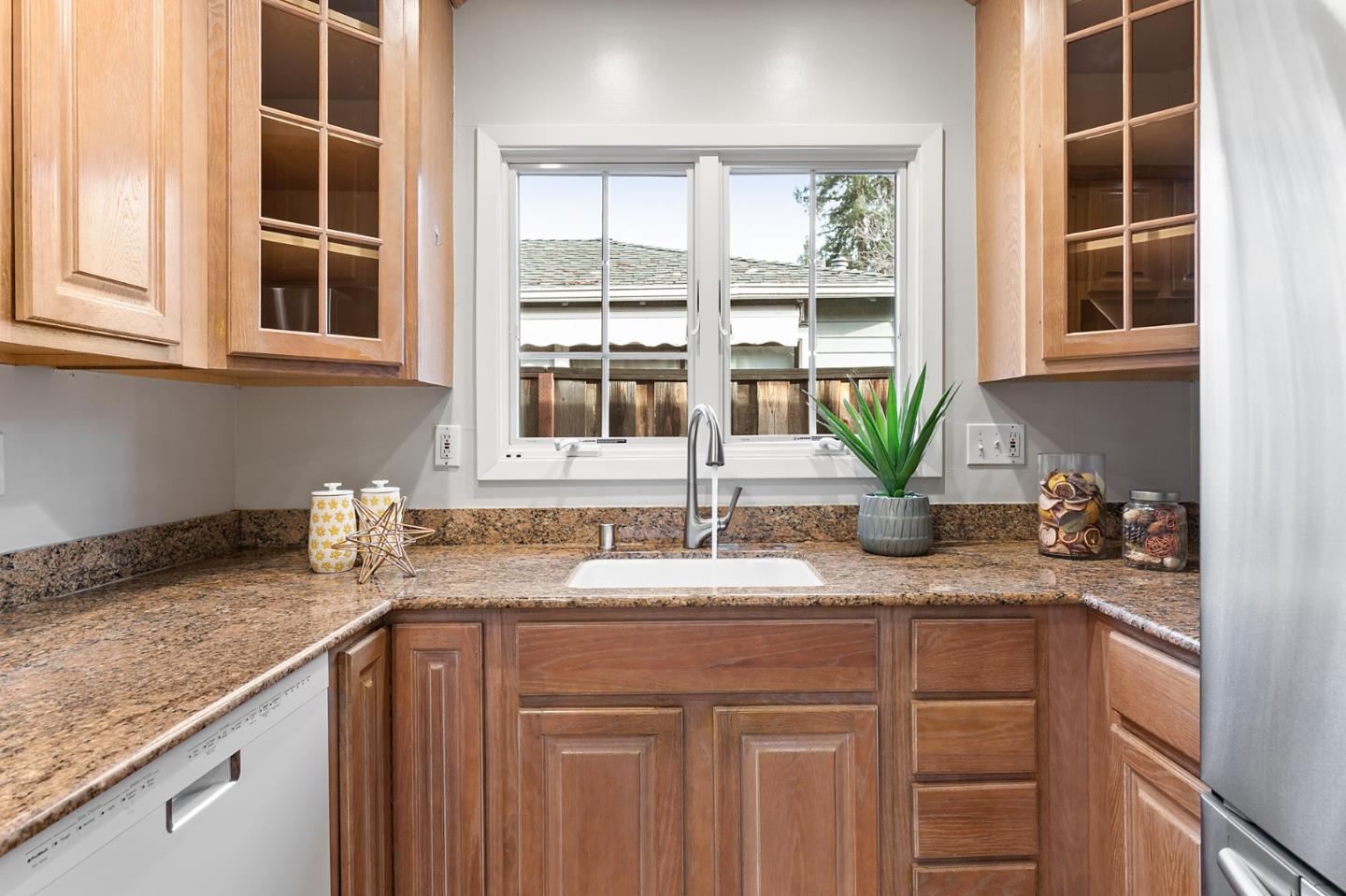 117 Hedge Road Menlo Park, CA 94025 - Photo 9 of 23 a kitchen with granite countertop a sink and a window