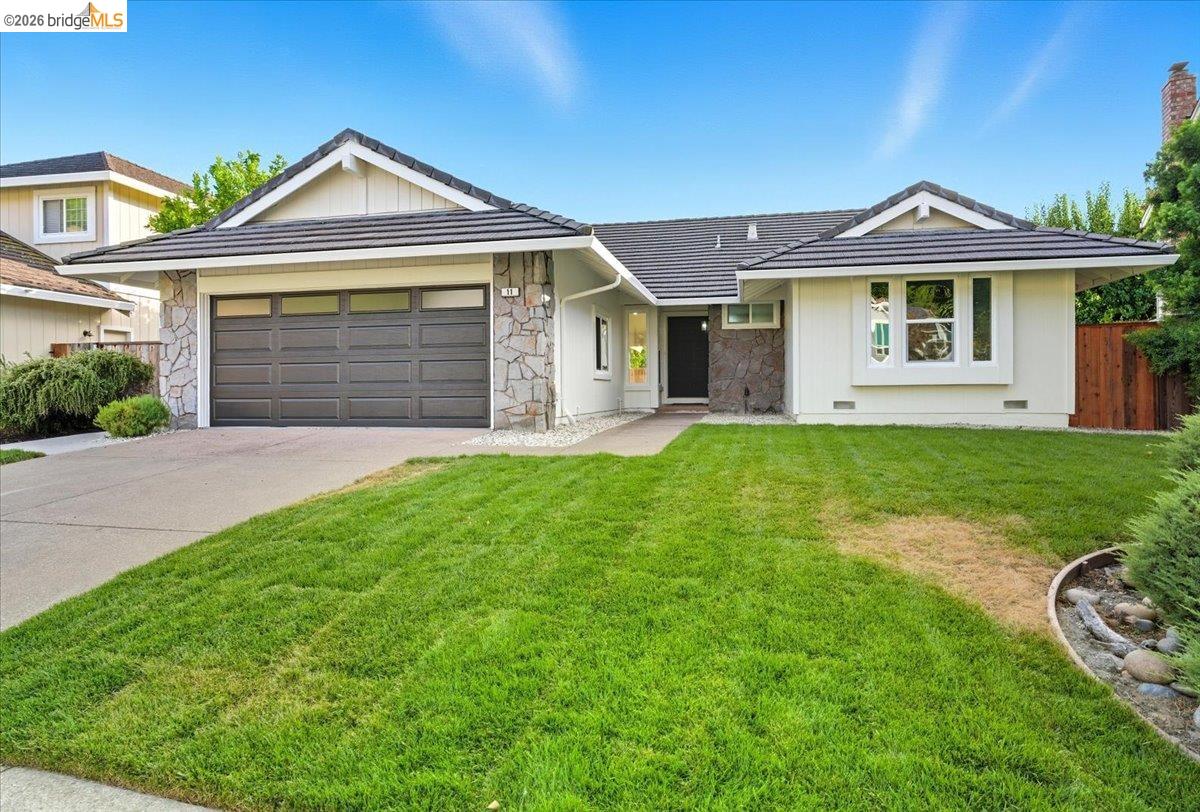 11 Paddock Court Pleasant Hill, CA 94523 - Photo 2 of 34 a front view of a house with a yard and garage