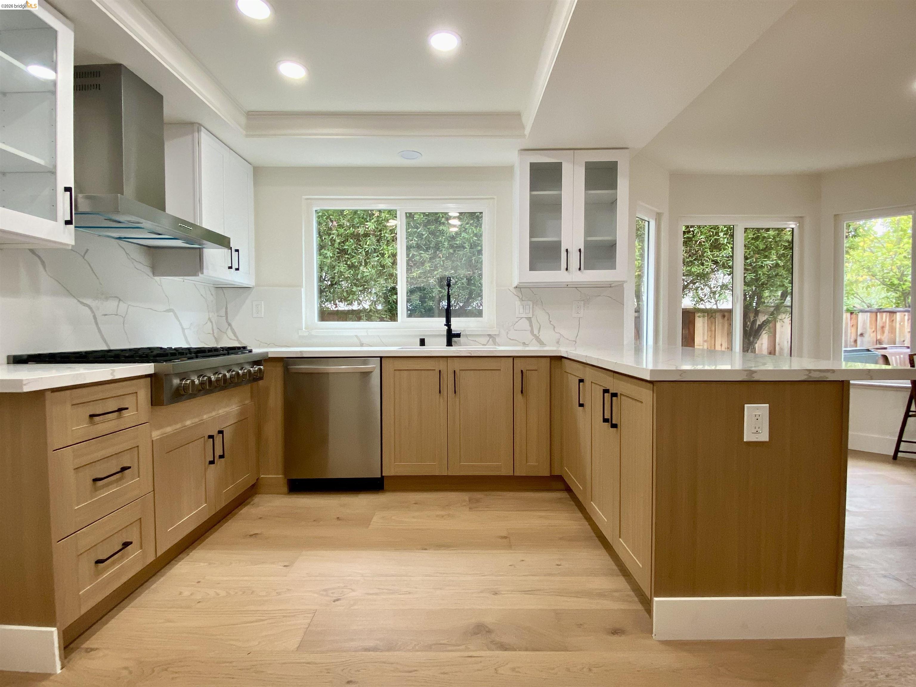 11 Paddock Court Pleasant Hill, CA 94523 - Photo 7 of 34 a large kitchen with stainless steel appliances granite countertop a stove a sink a refrigerator and white cabinets with wooden floor