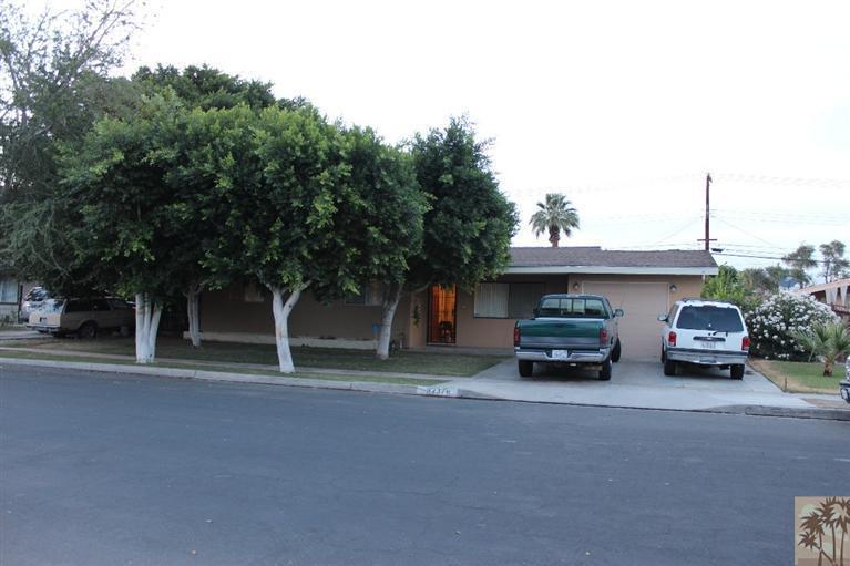 a couple of cars parked in front of a house