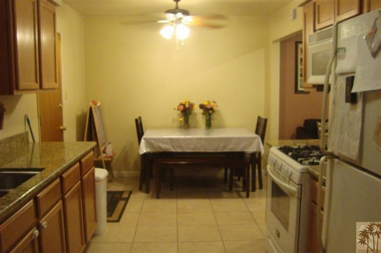 82376 Adobe Road Indio, CA 92201 - Photo 3 of 7 a kitchen with a stove and a refrigerator