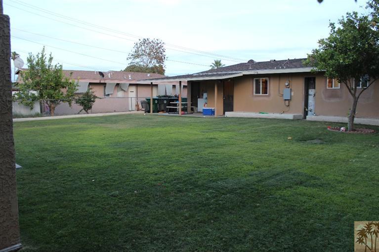 82376 Adobe Road Indio, CA 92201 - Photo 6 of 7 a view of a yard in front of a house with a large tree