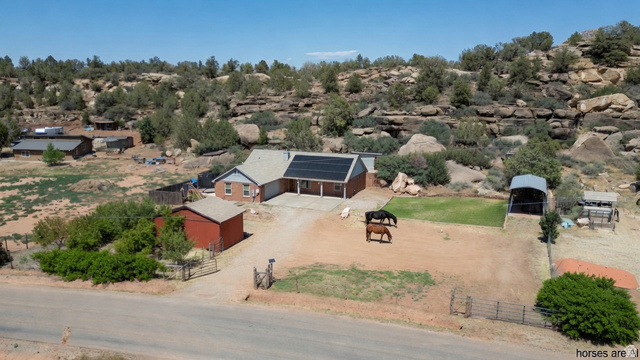 1504 Rome Way Apple Valley, UT 84737 - Photo 1 of 22 Ranch-style residence featuring a brick and siding exterior, an attached garage, and visible rooftop solar panels