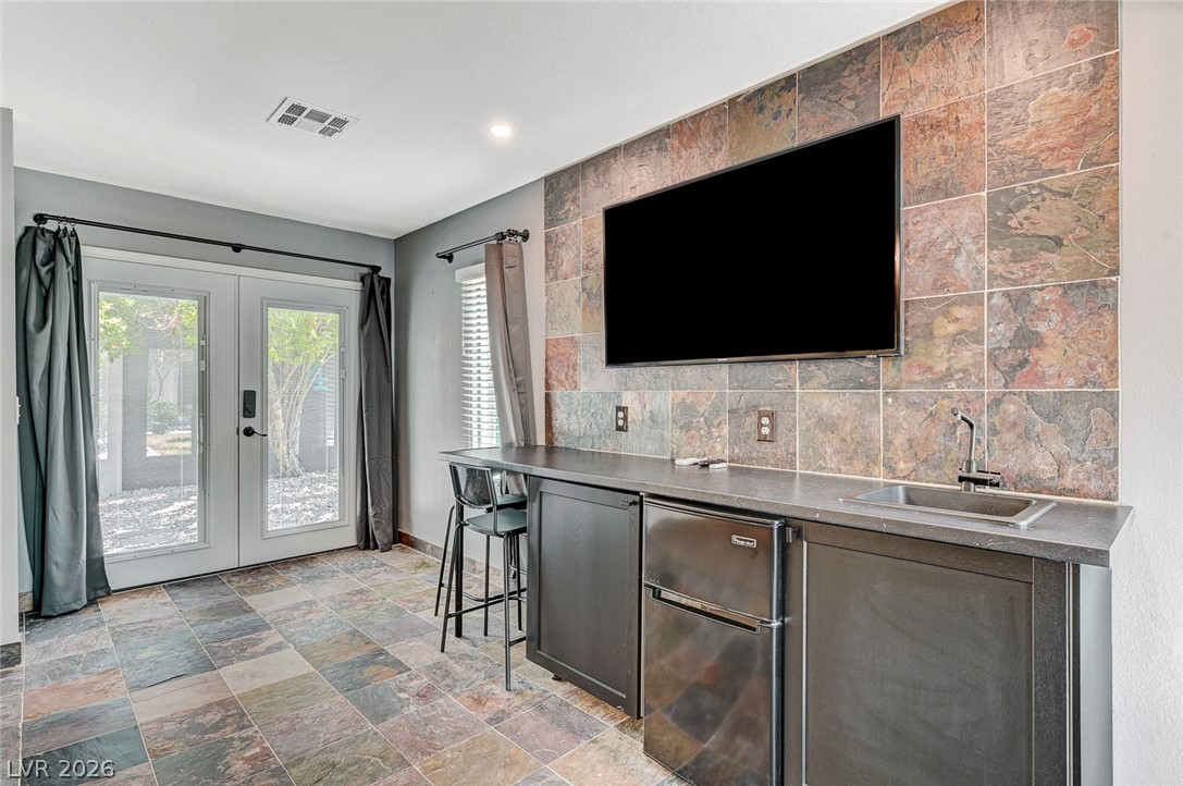 4153 Woodcrest Road Las Vegas, NV 89121 - Photo 30 of 58 A well-appointed recreation space features a wet bar, perfect for entertaining.
