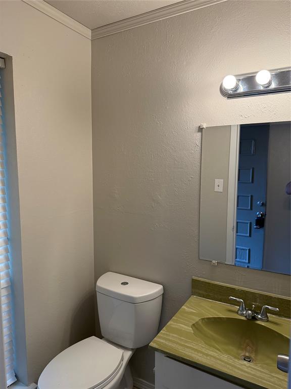 3629 Rickshaw Drive, Unit 3633 Dallas, TX 75229 - Photo 3 of 12 a bathroom with a toilet sink and mirror