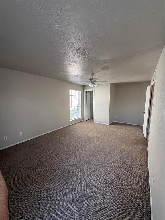 3629 Rickshaw Drive, Unit 3633 Dallas, TX 75229 - Photo 5 of 12 a view of empty room with windows