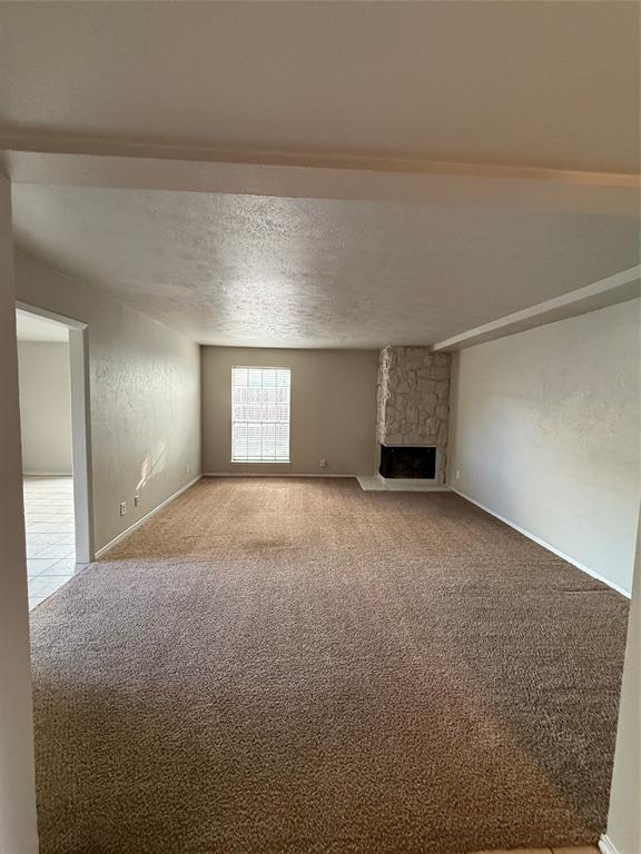 3629 Rickshaw Drive, Unit 3633 Dallas, TX 75229 - Photo 7 of 12 a view of empty room with a fireplace and window