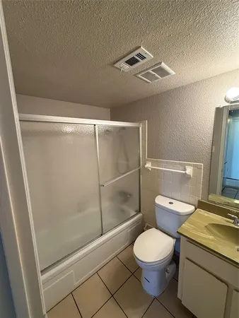 a bathroom with a toilet a sink and shower