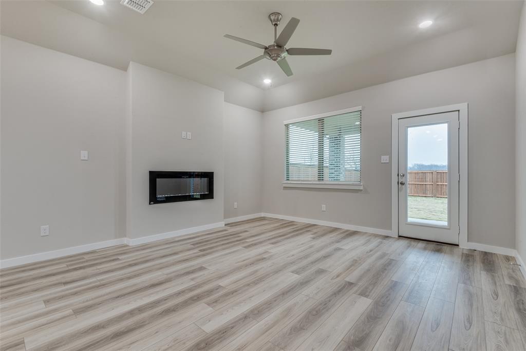 2544 Rambling Road Celina, TX 75009 - Photo 3 of 25 Unfurnished living room with light wood-type flooring and ceiling fan
