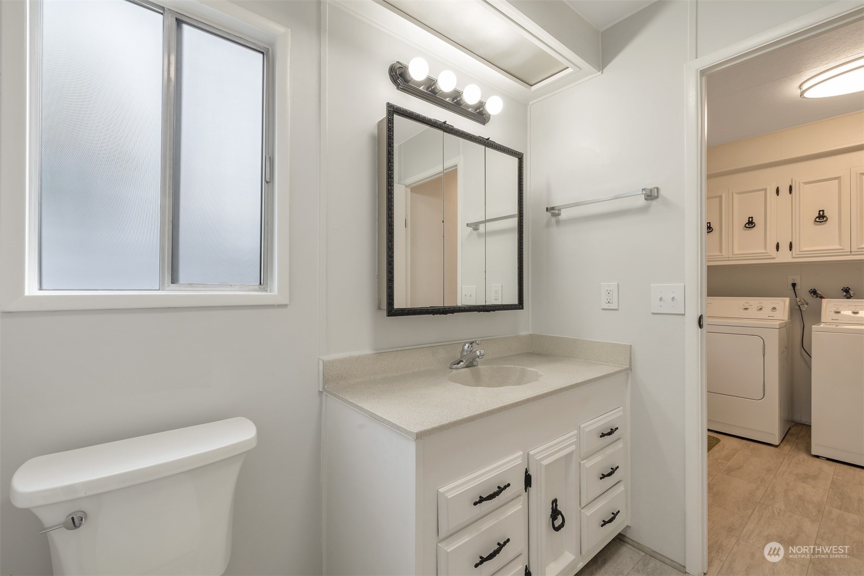 1121 244th Street Southwest, Unit 1 Bothell, WA 98021 - Photo 19 of 25 a bathroom with a sink toilet and mirror
