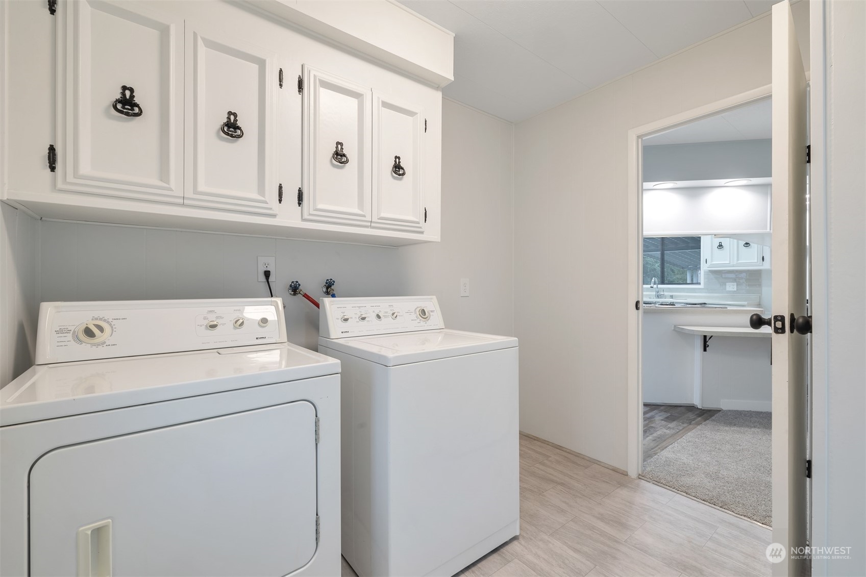 1121 244th Street Southwest, Unit 1 Bothell, WA 98021 - Photo 20 of 25 a view of washer and dryer with bathroom in the background