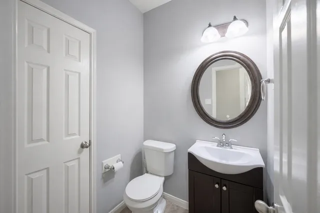 a bathroom with a sink a toilet and a mirror