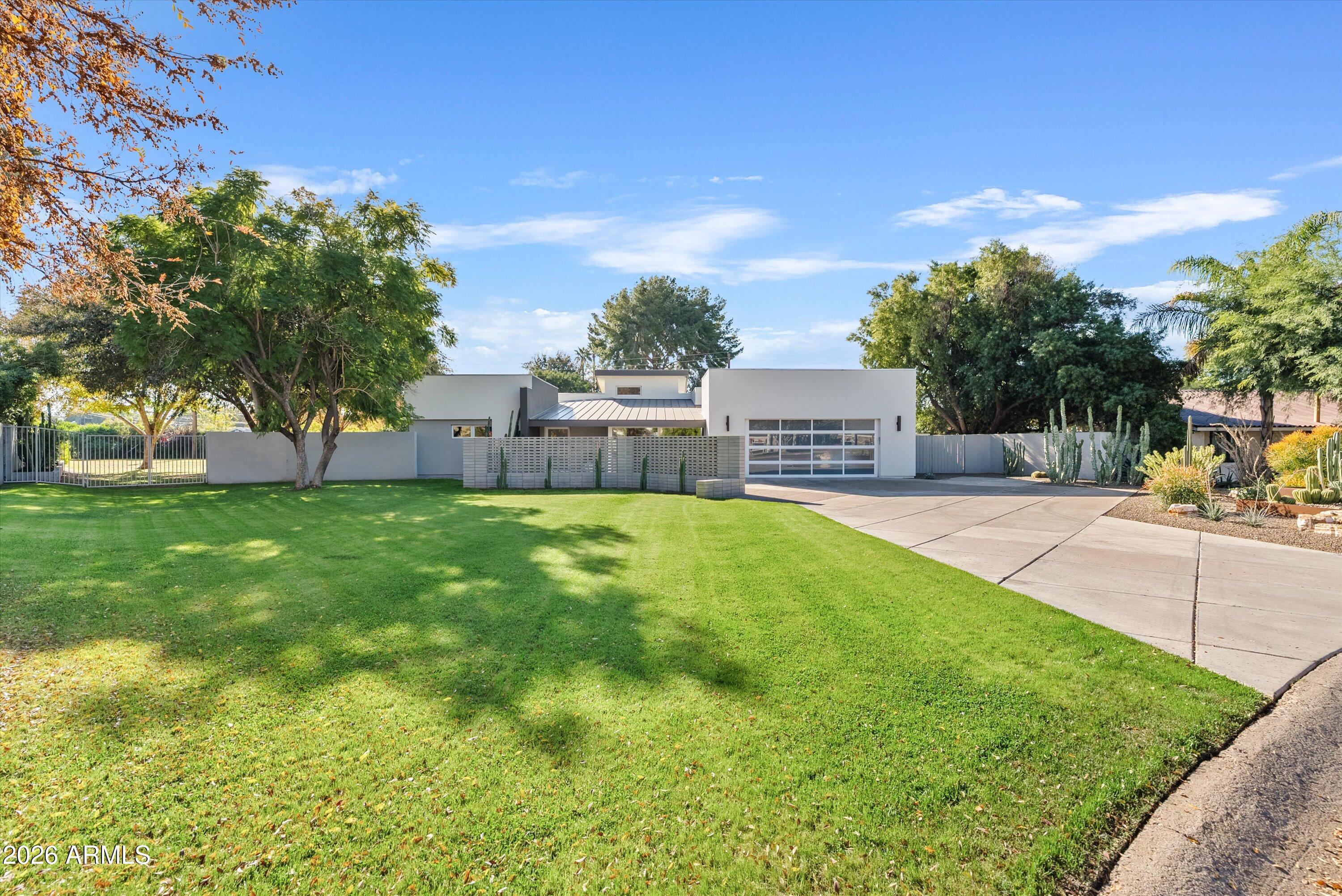 a view of house with a backyard