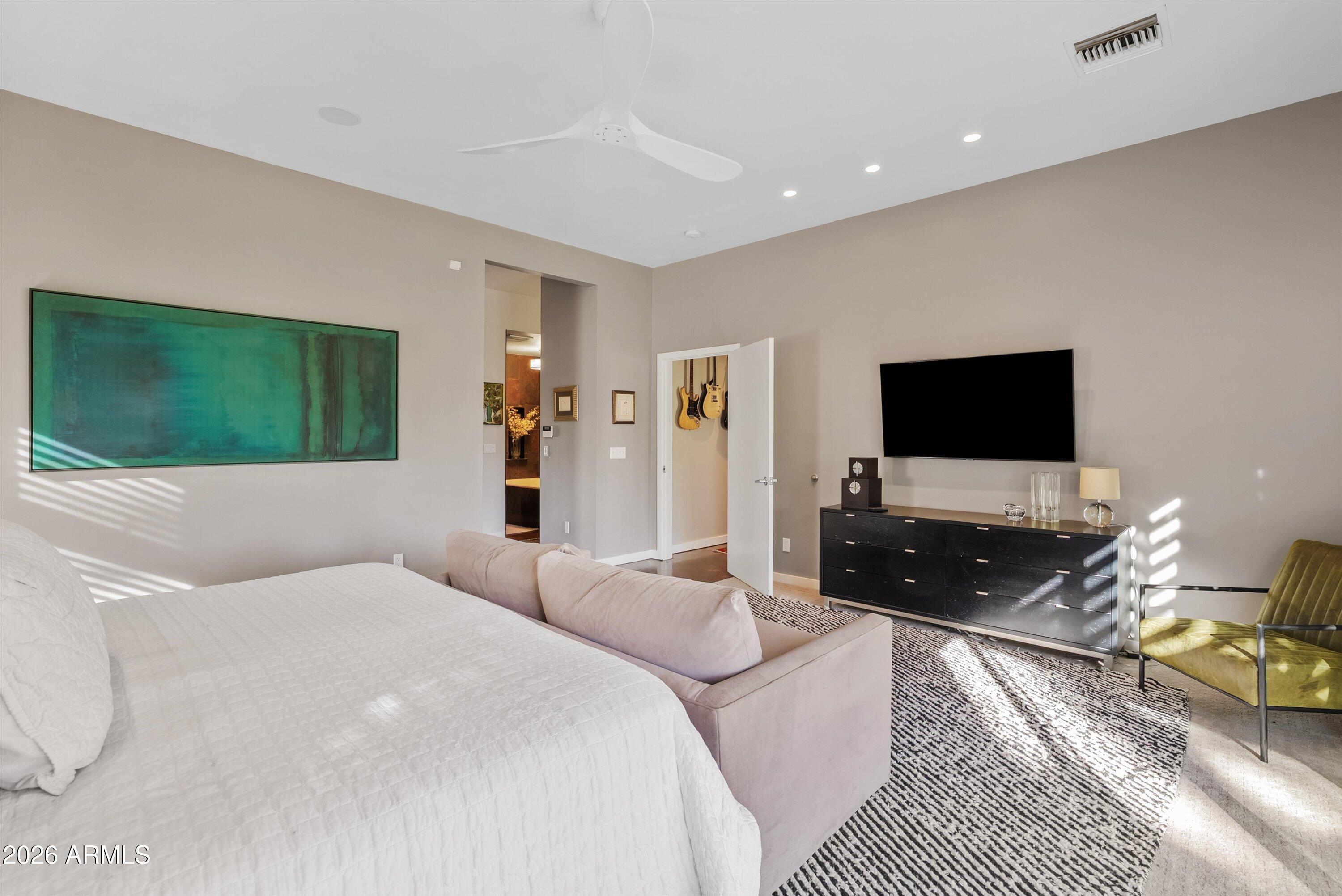 2933 East Pierson Street Phoenix, AZ 85016 - Photo 12 of 28 a bedroom with a bed and a flat screen tv