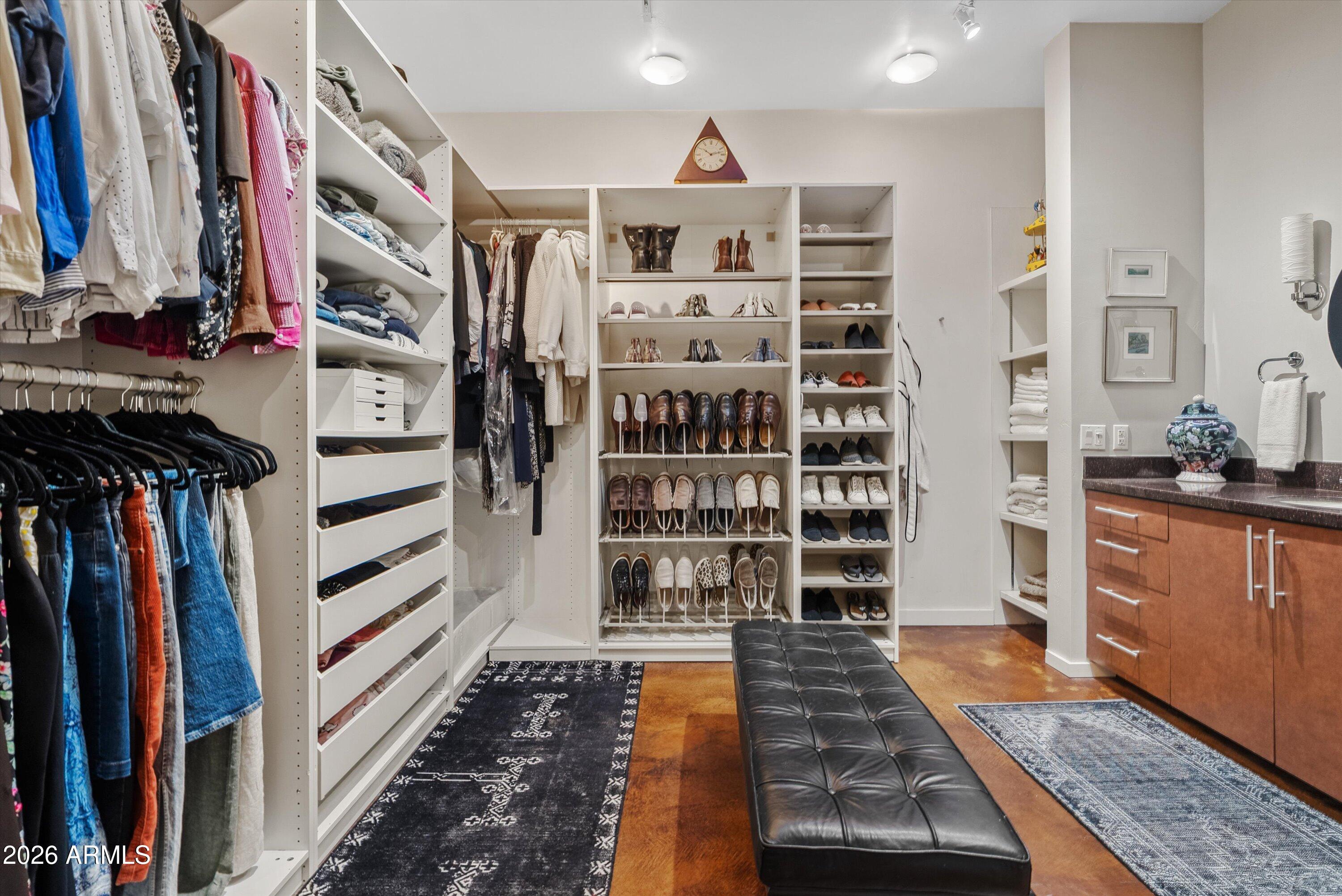 2933 East Pierson Street Phoenix, AZ 85016 - Photo 13 of 28 a view of walk in closet with clothes and shoes