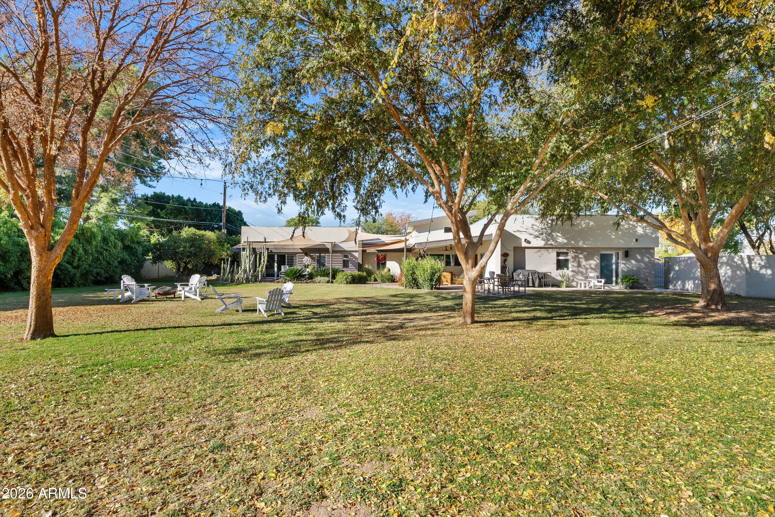 2933 East Pierson Street Phoenix, AZ 85016 - Photo 24 of 28 a view of a swimming pool with a garden and trees