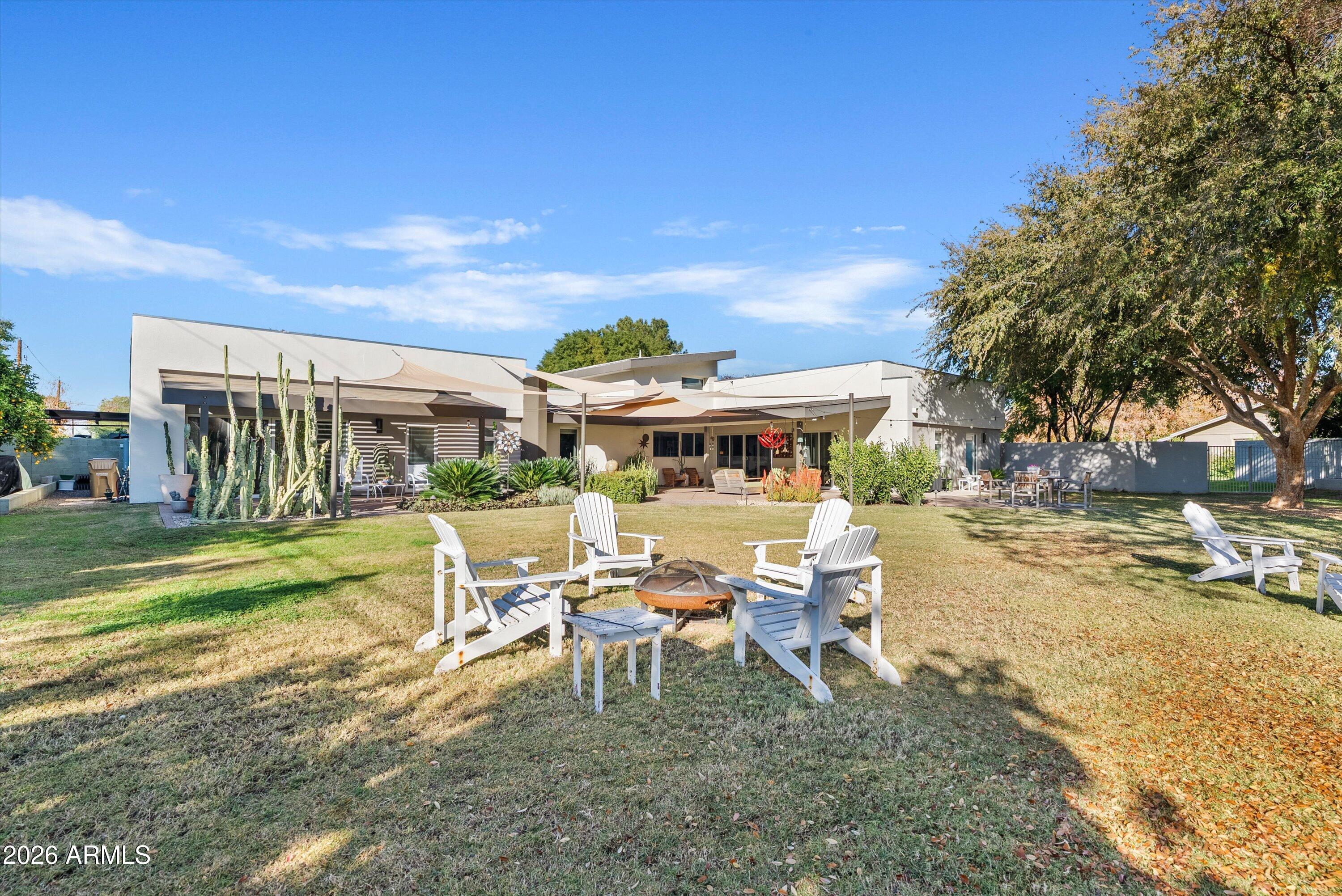 2933 East Pierson Street Phoenix, AZ 85016 - Photo 27 of 28 a view of a white house with a big yard and sitting area