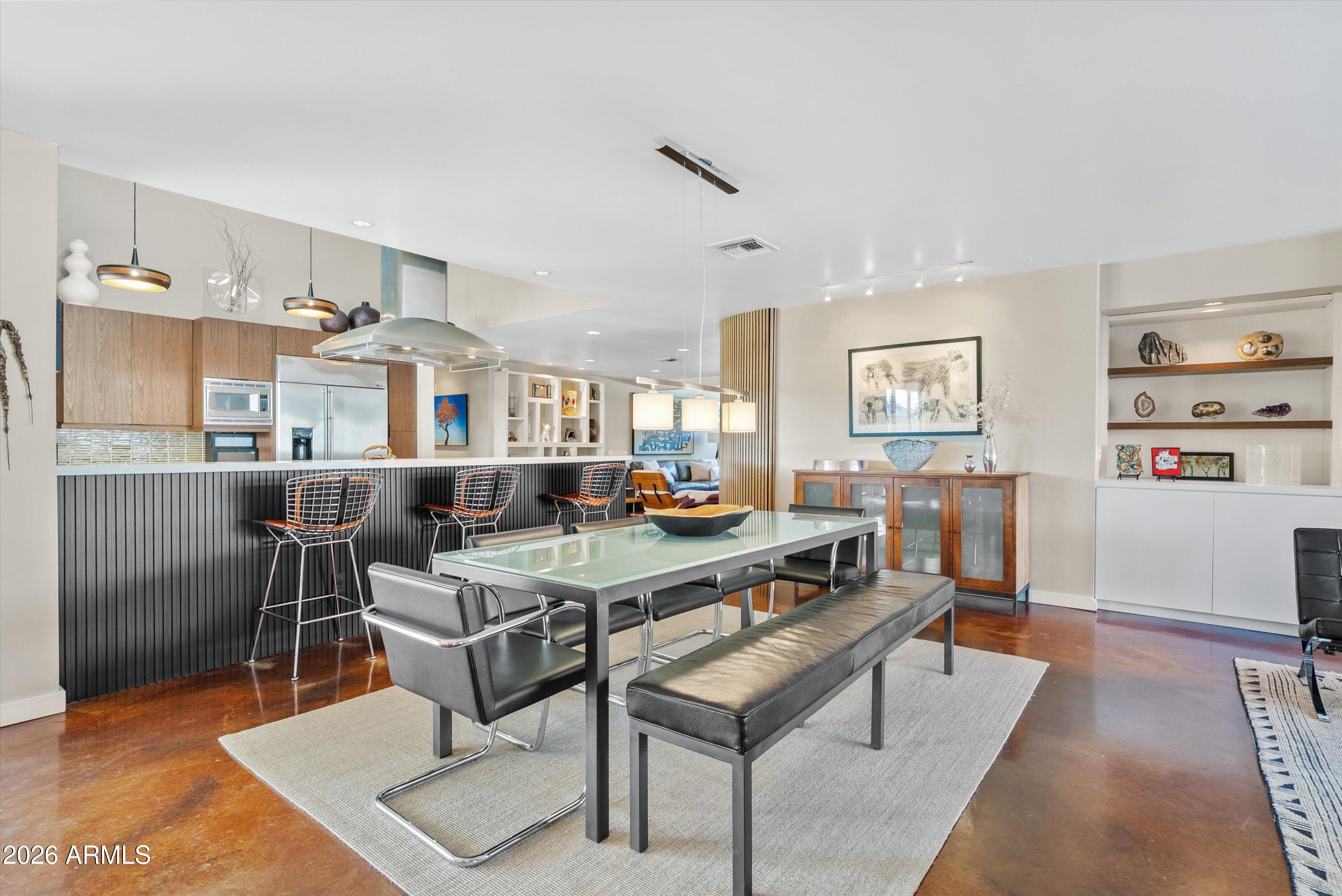 2933 East Pierson Street Phoenix, AZ 85016 - Photo 6 of 28 a living room with stainless steel appliances furniture a rug and a dining table with wooden floor