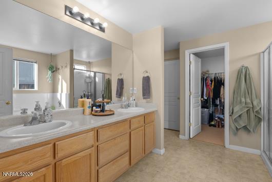 552 Spur Court Fernley, NV 89408 - Photo 26 of 46 a bathroom with a double vanity sink a and a mirror
