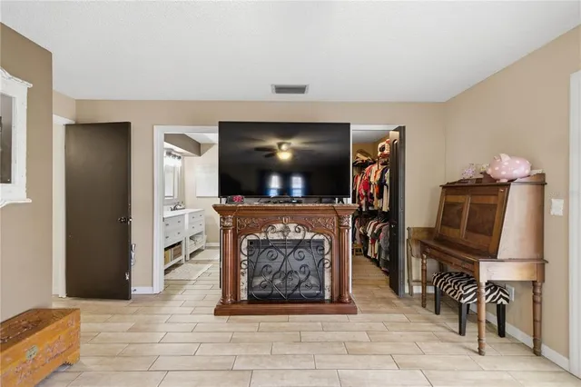 a living room with fireplace furniture and a flat screen tv