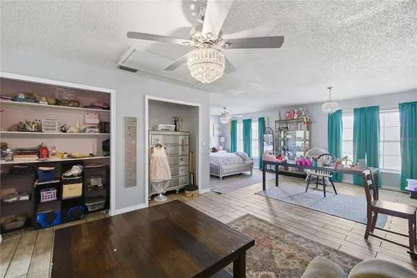 a living room with furniture a clock and a chandelier