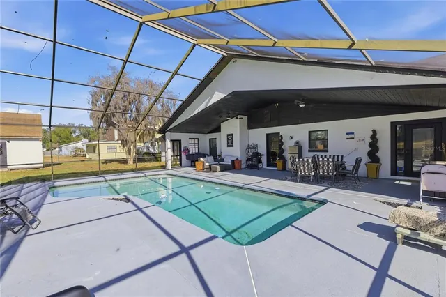 a view of a gym with pool table and chairs