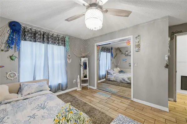 a bedroom with a large bed and a chandelier