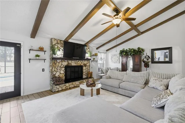 a living room with furniture a fireplace and a flat screen tv