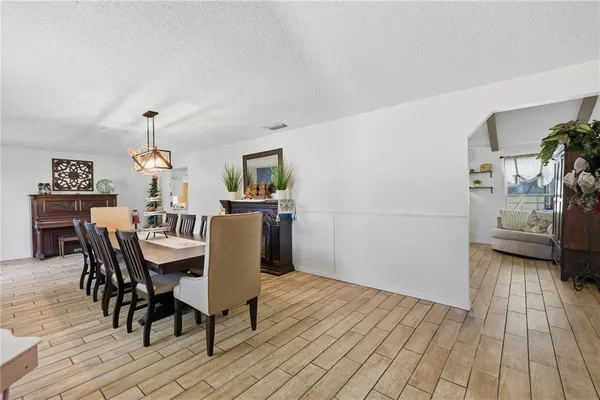 a dining room with furniture and wooden floor