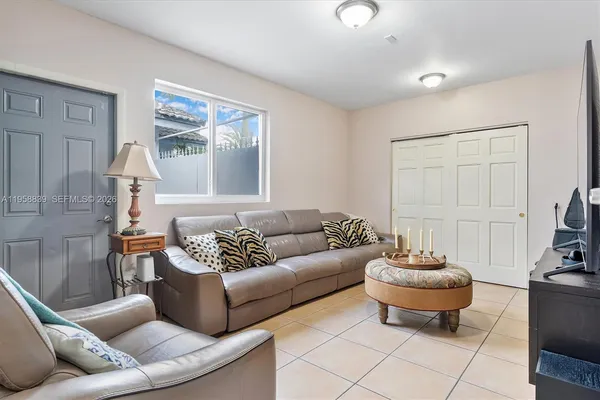 a living room with furniture and a large window