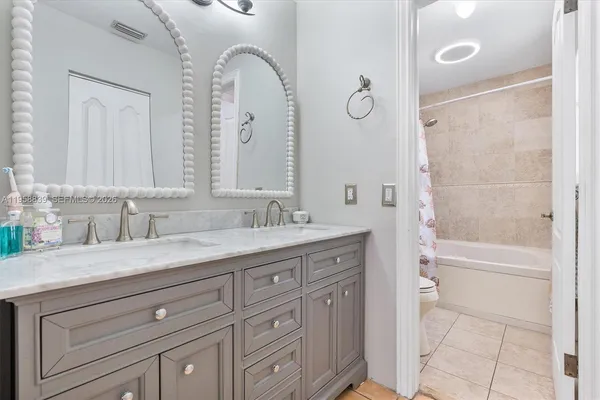 a bathroom with a granite countertop sink mirror and