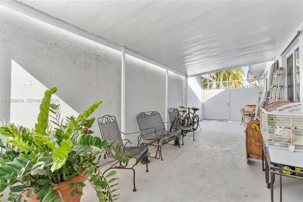 a dining room filled with furniture and a potted plant