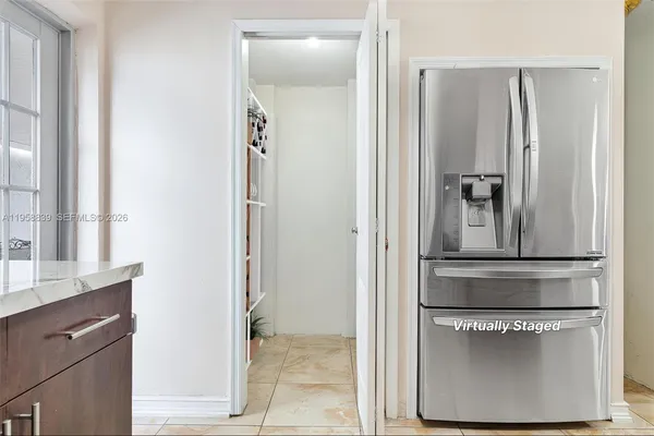 a utility room with closet and windows