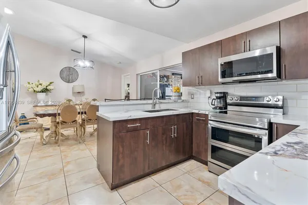 a kitchen with a stove a sink and a microwave