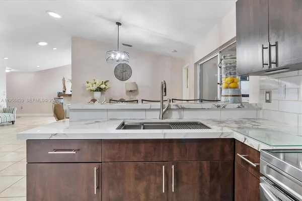a bathroom with a granite countertop sink a large mirror and vanity