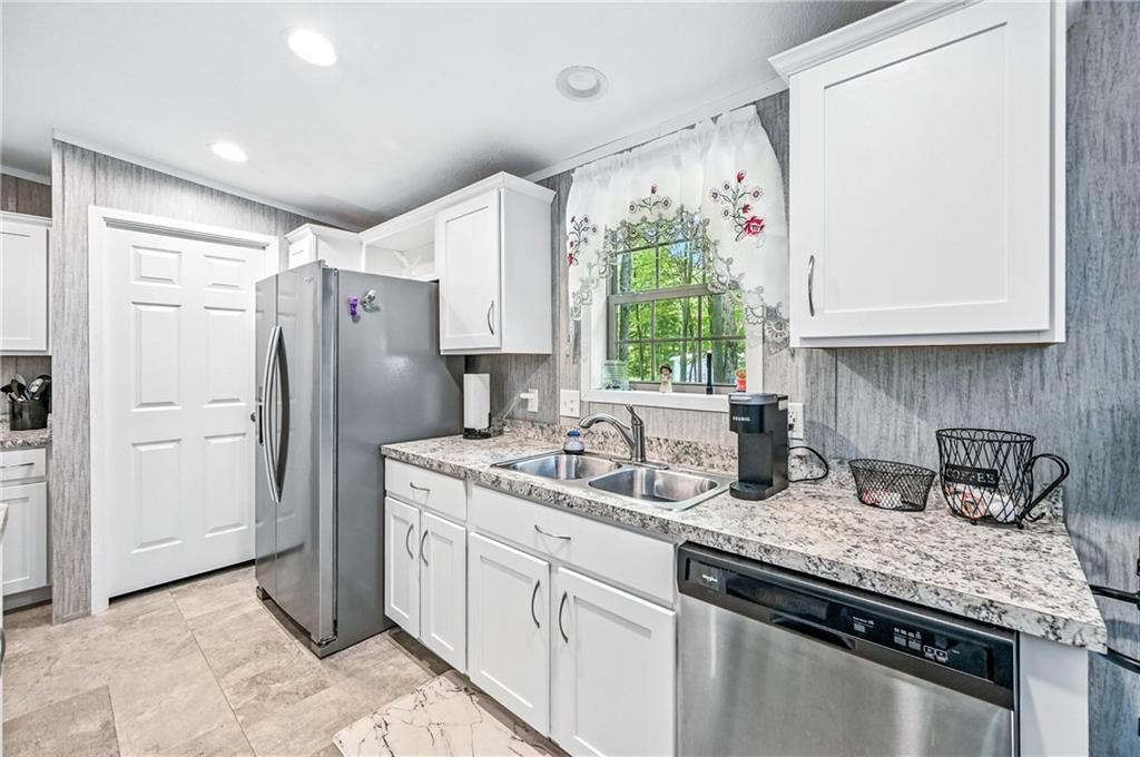 73 South Summit Road, Unit 503 Greenville, PA 16125 - Photo 10 of 36 a kitchen with stainless steel appliances granite countertop a sink stove and refrigerator