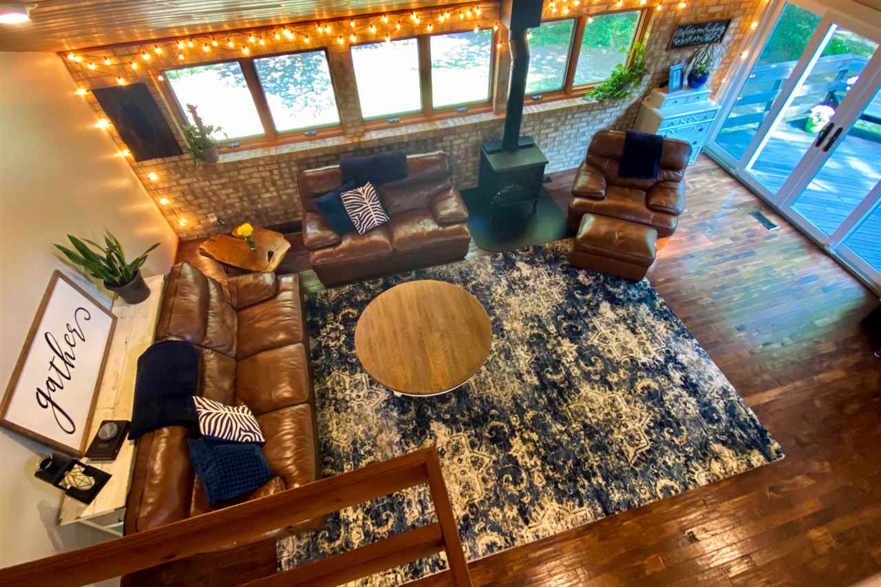 580 Kelly Road Caledonia, IL 61011 - Photo 31 of 40 a living room with furniture and a floor to ceiling window