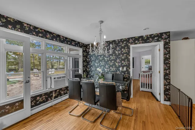 a view of a livingroom with furniture wooden floor and windows