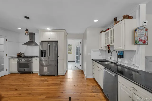 a kitchen with stainless steel appliances granite countertop a sink and a stove