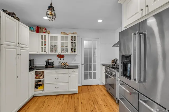 a kitchen with sink a microwave and cabinets